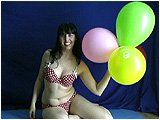 Heather inflates a balloon bouquet by mouth