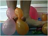 Adele teases small balloons with her feet