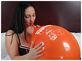 Kedra slowly inflates a pair of balloons