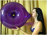 Video clip for sale of Eira blowing to burst a geo blossom and geo donut balloon
