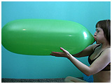 Adele blows to pop a big green jellybean balloon