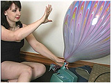Video clip for sale of Lily blowing to pop a couple of peacock balloons