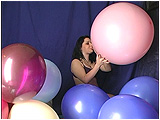 Kat blows to burst a pretty pink 20-inch balloon