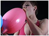 Video clip for sale of Celia blowing to burst blimp balloons
