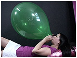 Alexxia blows to pop a 16-inch balloon