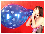 Video clip for sale of Alexxia blowing to pop a 16-inch Qualatex spray balloon