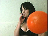 Kat smokes a Virginia Slims while inflating a balloon