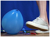 Alexxia footpops balloons in her Keds