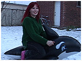 Xev takes an inflatable whale for a ride in the snow
