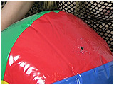 Debby smokes while inflating and then cig-popping a beachball
