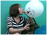 Adele inflates a clown-faced balloon while smoking