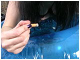 Heather smokes while inflating a swim ring