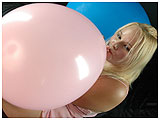 Annie inflates a pink balloon