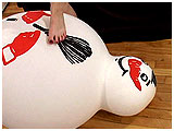 Video clip for sale of Sam foot-teasing a huge snowman balloon